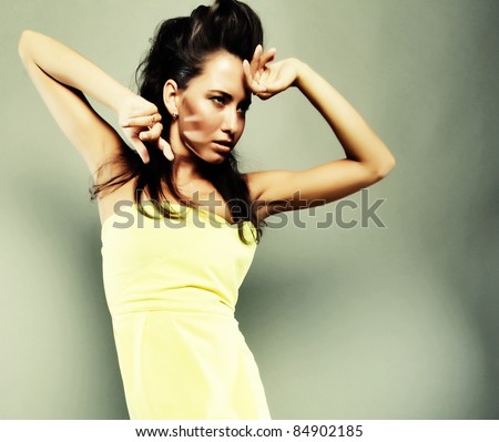 Fashionable pretty woman in yellow dress