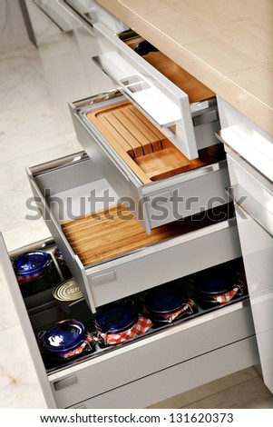 Modern kitchen drawers with compartments for various things.