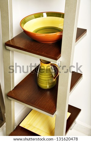 Simple kitchen shelves with colorful pottery.