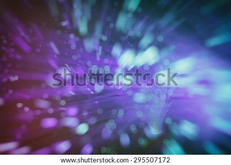 colored particles fly in space of the optical fiber and circling ( abstract blur background  )