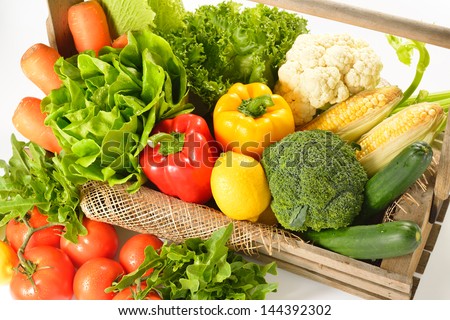 fruits and vegetables in wooden basket on white background