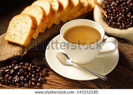Coffee cup with sliced bread  and fresh coffee beans