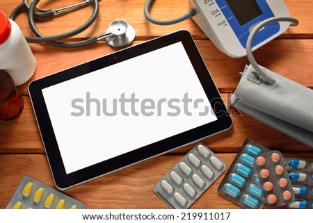 Tablet pc computer with medicines, stethoscope and automatic blood pressure
