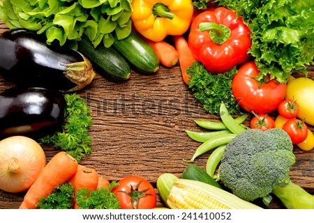 Vegetables and fruits on old wooden background