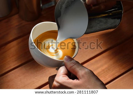 Making of cafe latte art, tulip shape