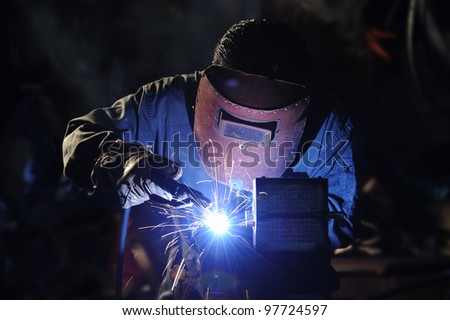 skilled working factory welder.