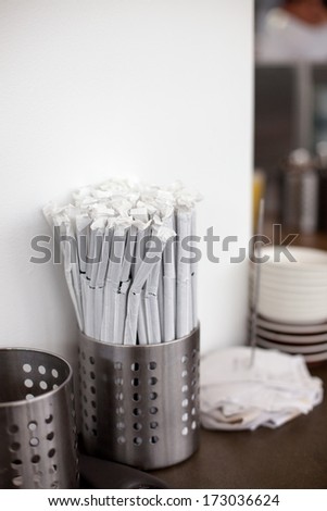 Container with straws in a restaurant
