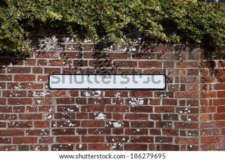 Blank road sign on a brick wall