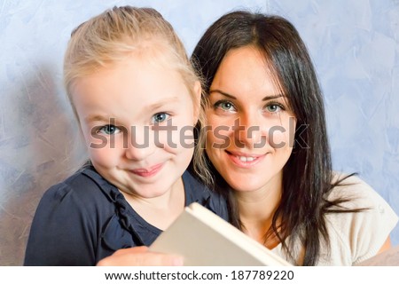 Photo of mother and daughter are reading a book