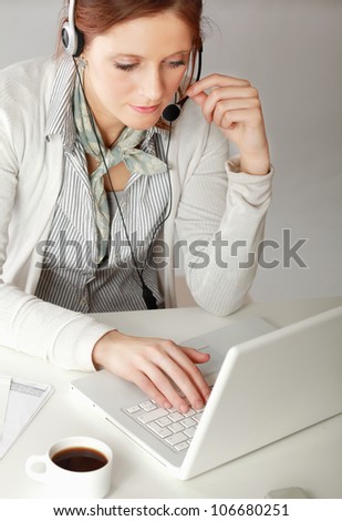 Young customer service operator with laptop isolated