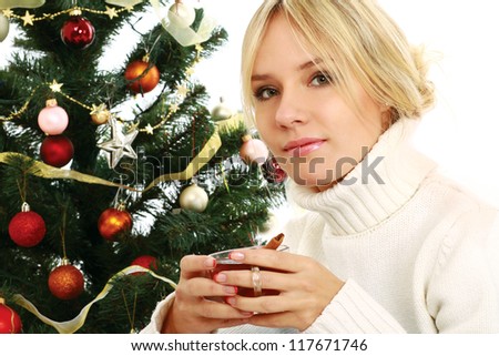 Woman with cup of tea near christmas tea