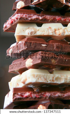 Stack of chocolate pieces on black background