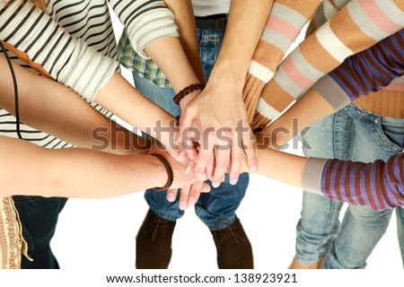 friends putting their hands together in a sign of unity and teamwork
