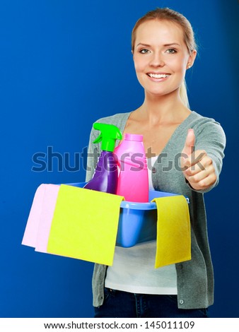 The portrait of girl - concept Cleaning and showing ok, isolated on blue background