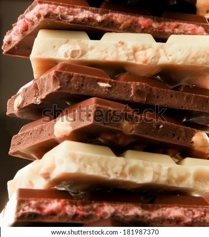 Stack of chocolate pieces on black background