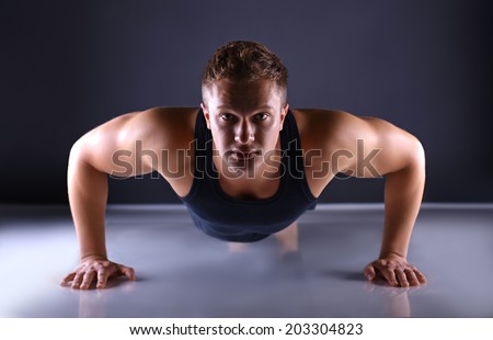 Muscular young man doing press-ups