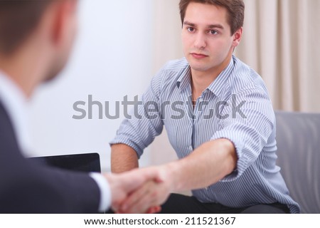 Business people handshake, sitting in the office