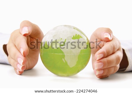 Hands holding a green earth, isolated on white background