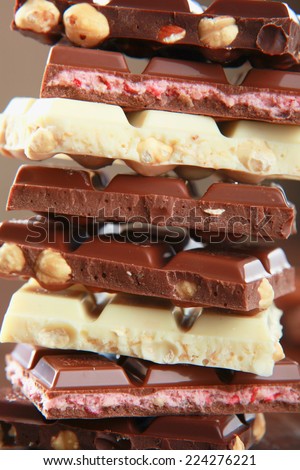 Stack of chocolate pieces on a wood background