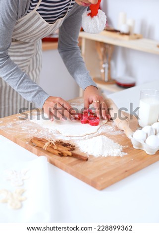 Woman making christmas cookies in the kitchen