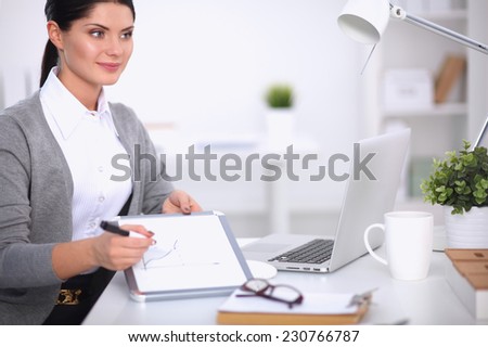 Beautiful businesswoman handing over paperwork extending her hand