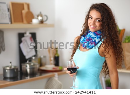 Kitchen Woman. Pretty woman drinking some wine at home