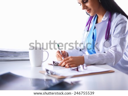 Female doctor sitting on the desk with paper  and working