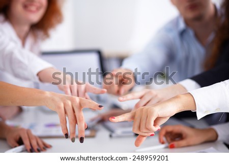 Business people group team point finger at you