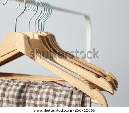 Clothes hang on a shelf in  designer clothes store