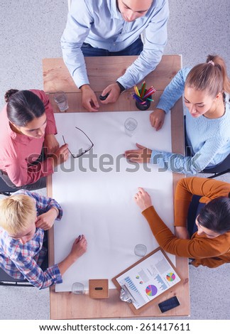 Business people sitting and discussing at business meeting, in office