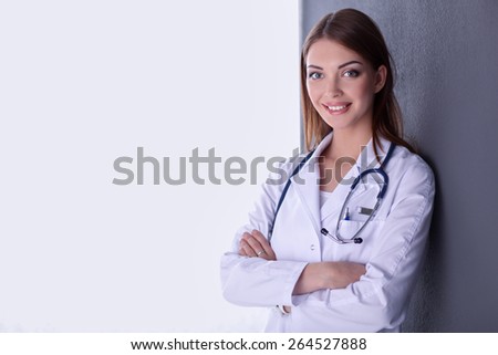 Doctor woman with stethoscope isolated on grey background