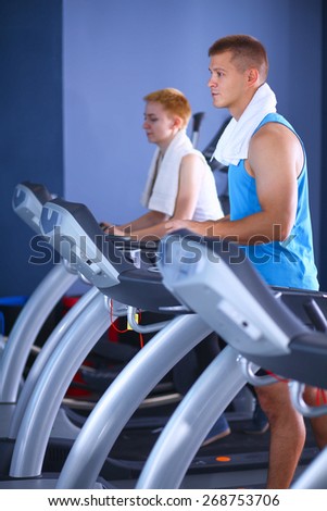 Group of people at the gym exercising on cross trainers