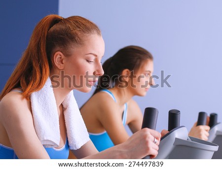 Beautiful girl at the gym exercising on trainers