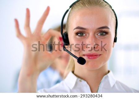 Smiling customer service girl showing ok, isolated on white background.