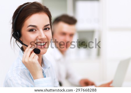 Businesswoman with headset smiling at camera in call center