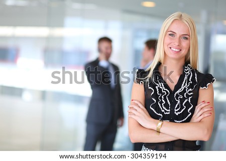 Business woman standing in foregroundPlease tick the 