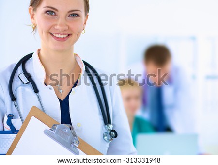 Attractive female doctor  with folder in front of medical group