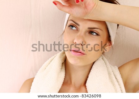 Portrait of a beautiful young lady with a towel relaxing after her regular exercises