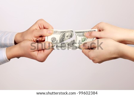 Hands tear money isolated on white background