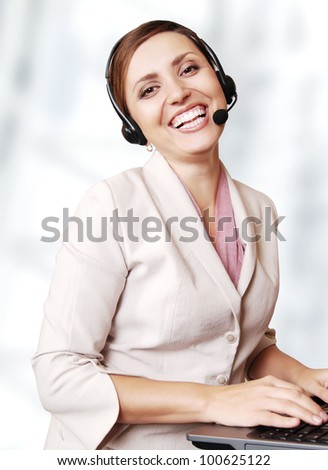 Happy smiling young woman call center operator at her workplace