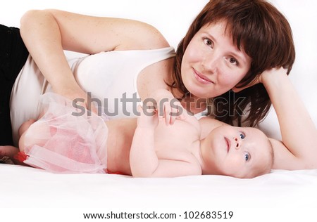 Mother with infant daughter lying on the bad