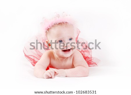 Happy smiling baby girl in pink crown and red tutu