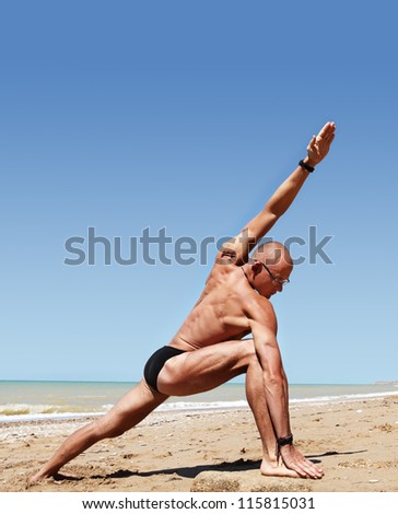 Yoga practice. Athletic build young man doing wide angle yoga pose