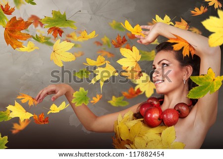 Lady Autumn in swirling falling leaves