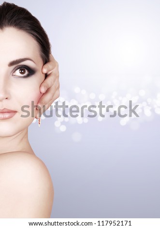 Beautiful woman face with fashion makeup  in cold tones