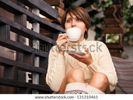 Alone girl drinks coffee at cozy home