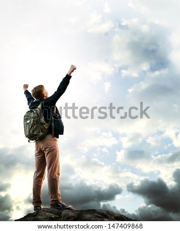 Triumphing young man on the top of mountain Triumphing young man on the top of mountain