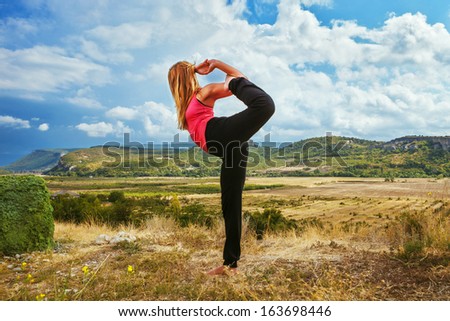 Yoga outdoor. Beautiful slim woman do  King of dance yoga pose