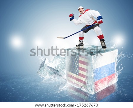 USA - Russia game. Spunky hockey player on ice cube