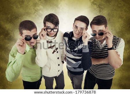 Four cool guys looking fixedly over glasses